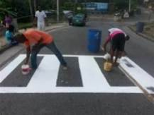 Men painting pedestrian crossing (Not actual photo)